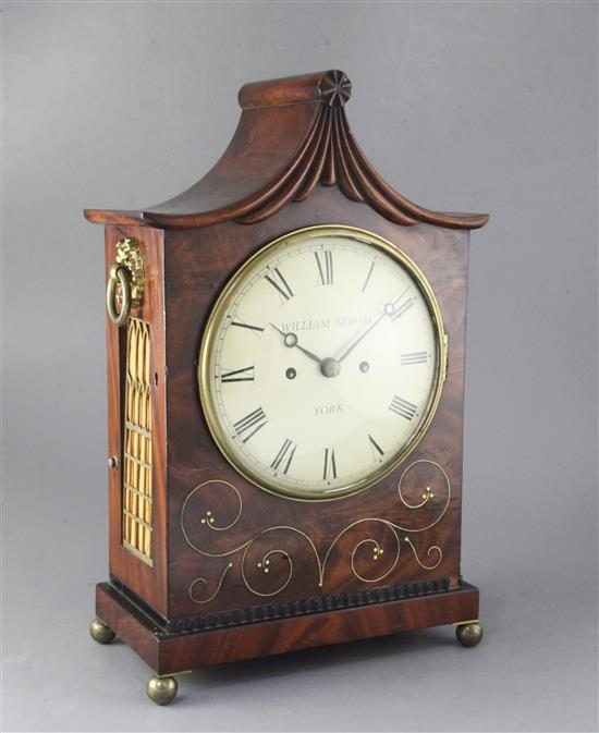 An early 19th century brass inlaid mahogany table clock and wall bracket